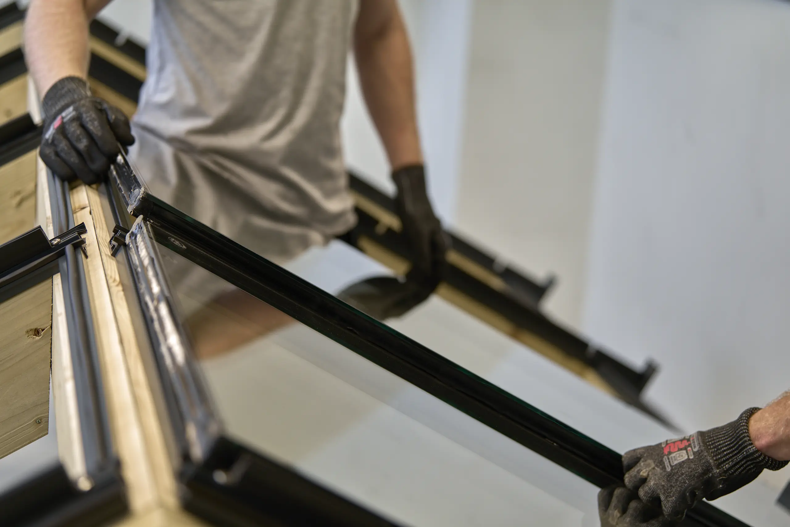 Frame installation - Glazing frame being positioned and aligned during assembly.