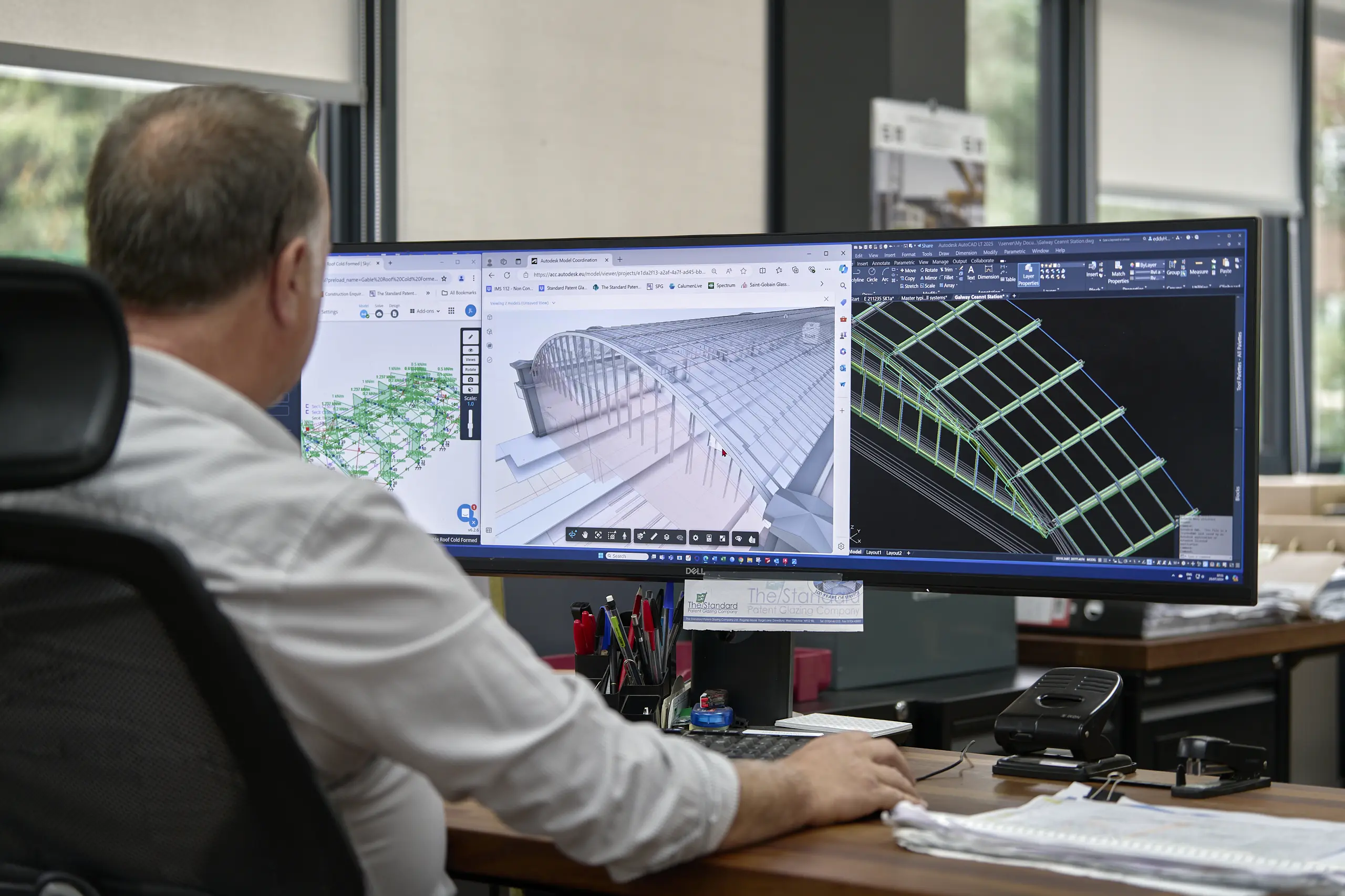 Design and engineering office - Technical team reviewing CAD models of complex glazing structures.